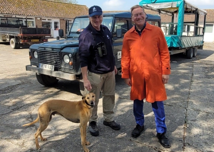 Dave Paynter stood with Michael Portillo and working dog Piper